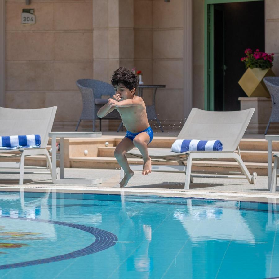 Al Masa Hotel Nasr City Cairo Ngoại thất bức ảnh A child jumping into a swimming pool